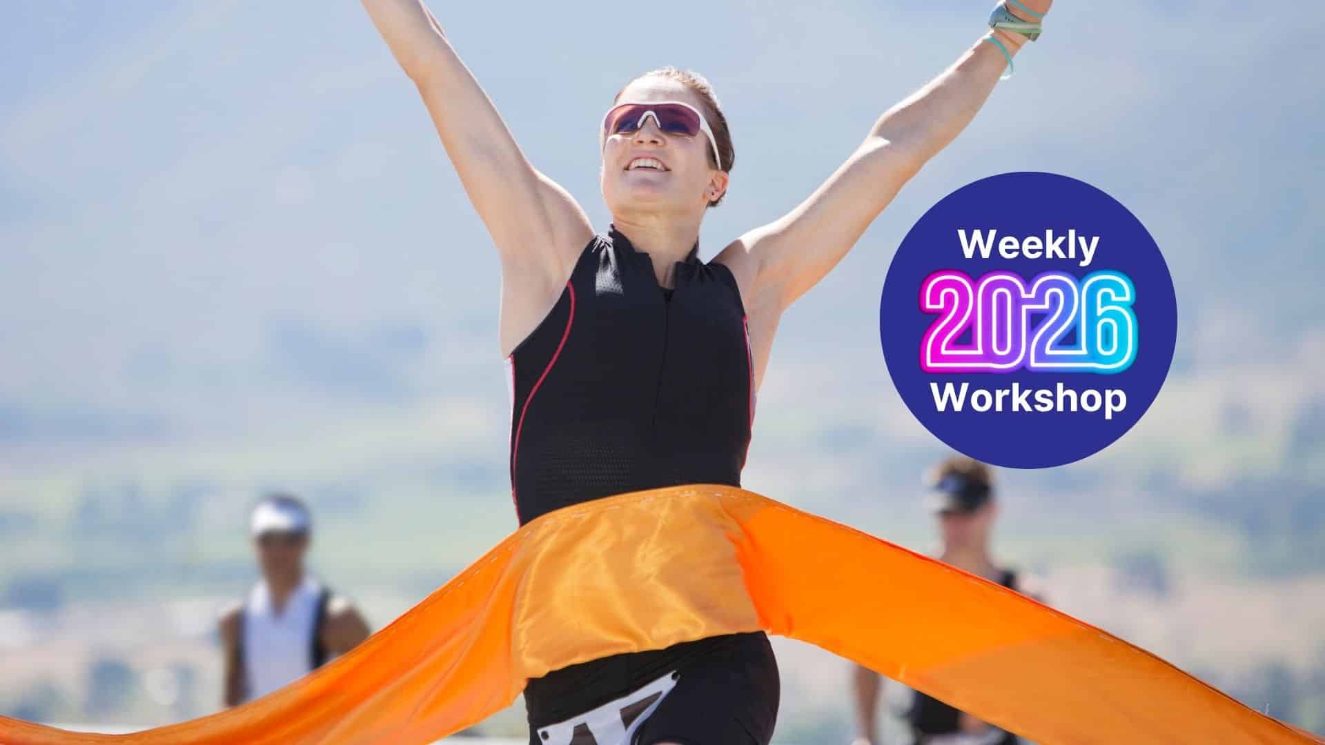 Female athlete celebrates a finish with arms raised as an orange ribbon streams by; a circular badge reads 'Weekly 2026 Workshop' on the right.
